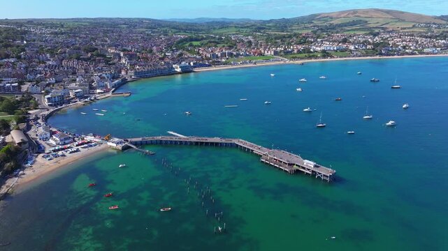 Aerial shot of Swanage Pier and seafront on a calm sunny day
