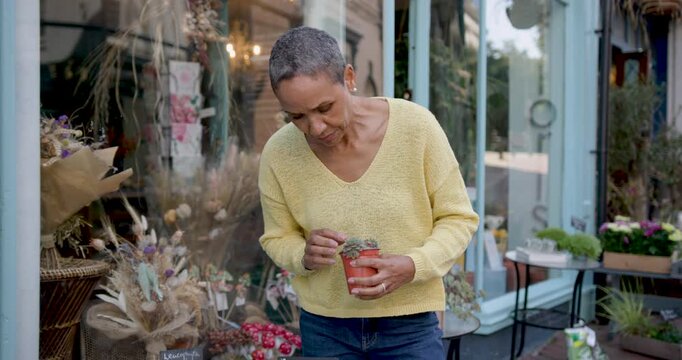Mature Woman Shopping for Plants Outside Shop