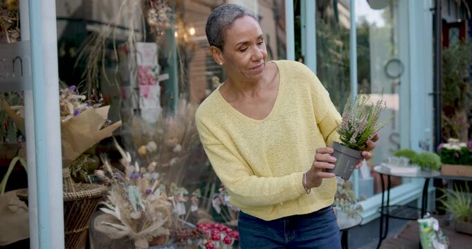 Mature Woman Shopping for Plants Outside Shop