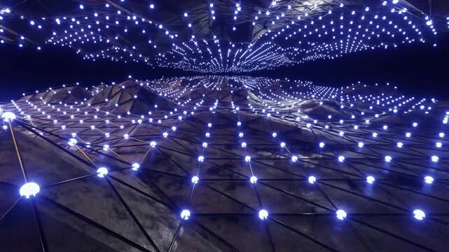 An angular geometric landscape (polyhedral wireframe) with a metallic texture, featuring a network of glowing blue light nodes at the top and bottom.