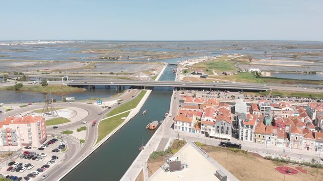 Aerial Drone Shot of the Main Canal, Salt Pans, Road and Railway Bridges and the Sea, Aveiro, Portugal
