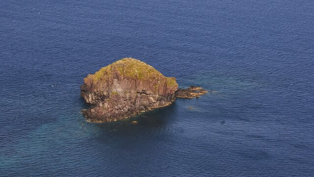 Rocky island in Pollara Bay, Salina island, small rocky island section surrounded by deep blue seawater, UNESCO World Heritage Site, Aeolian Islands, Aeolian Islands, Sicily, Italy