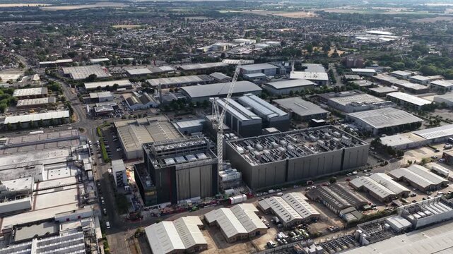 Aerial drone view of a large data center under construction in Slough, UK, showing infrastructure for AI computing, cloud services, servers, cooling and big data processing