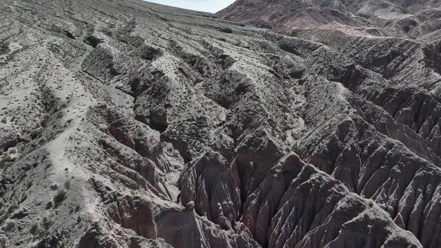Rock formations with remarkable geology. They are located just a few kilometers from the Hill of Seven Colors in Purmamarca, Jujuy, Argentina. A reverse drone flight.