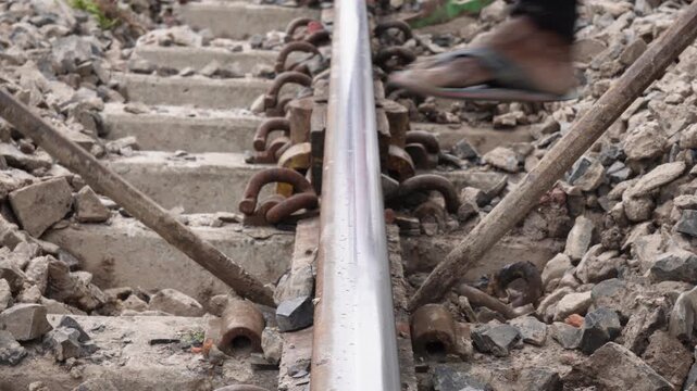 Railway worker maintaining steel track