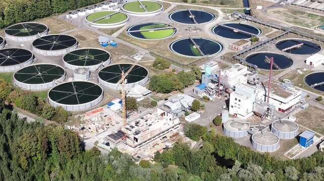 Aerial drone view of waste water treatment Karlsruhe, Germany, showing large-scale wastewater purification, clarifiers, treatment basins and municipal water infrastructure.
