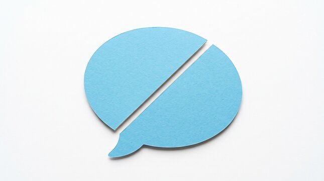 A light blue paper speech bubble cut into two separate pieces laying on a plain white background representing communication and disconnection.