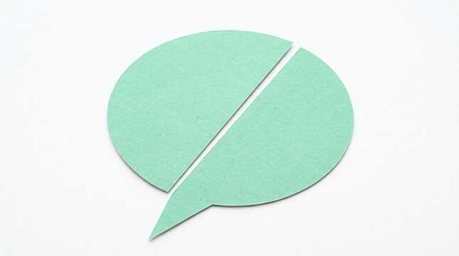A mint green paper speech bubble icon isolated on a white background split diagonally into two separate pieces representing broken