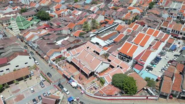 Aerial view of the historic Cheng Hoon Teng Temple surrounded by traditional red-tiled rooftops and narrow streets in Malacca, Malacca, Malaysia.