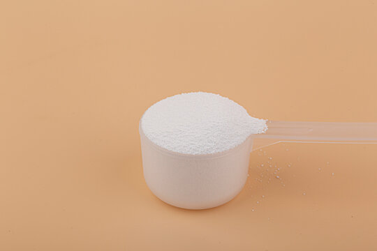 Sodium percarbonate powder in beige background.