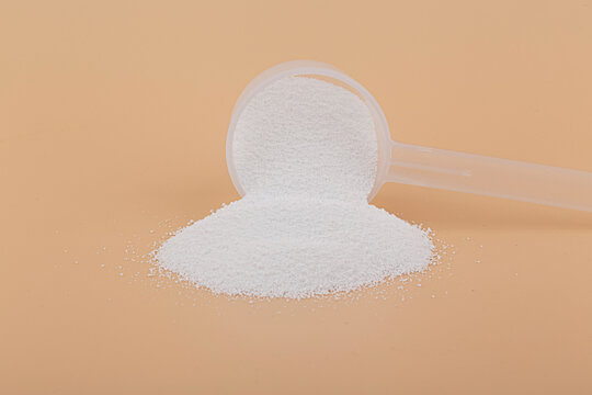 Sodium percarbonate powder in beige background.