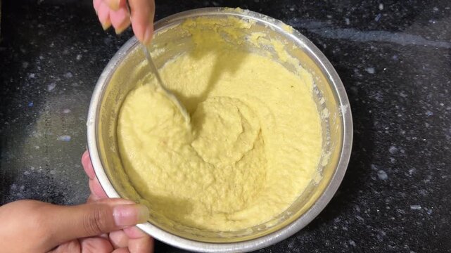 Person mixing hummus paste in a bowl 4k video footage