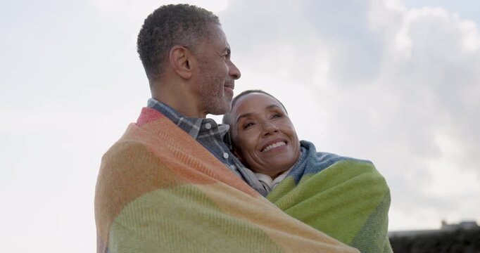 Senior Couple  Embracing Under a Colorful Blanket