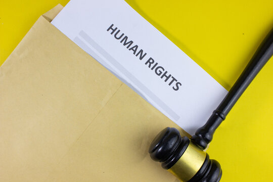 legal gavel with an envelope labeled HUMAN RIGHT, symbolizing justice, human rights protection, discrimination, bullying, defamation, criminal cases, genocide, equality, and legal action.