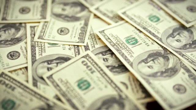 A smooth slider glides across a spread of vintage dollar bills on a wooden desk, emphasizing paper money, cash, and currency as tangible finance tools that circulate in everyday transactions