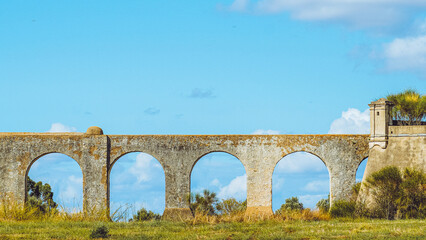 Historic Aqueduct of Silver Water in Evora Portugal under a clear blue sky © Marco