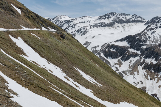 Furka Pass Alpine Landscape with Snow Covered Mountain Slopes in the Swiss Alps, Switzerland