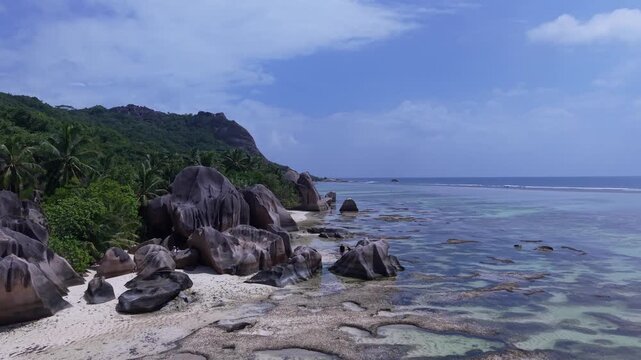 Aerial view of Anse Reunion beach featuring iconic granite boulders and turquoise waters along the coastline in Anse Reunion, La Digue, Seychelles.