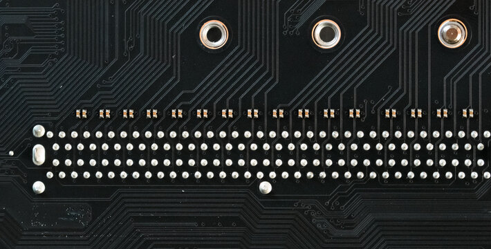 Macro shot of a complex printed circuit board surface revealing dense and intricate wiring traces.