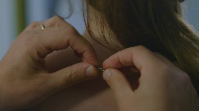 Close Up of Man Hands Fastening Necklace Clasp on Woman Neck, Romantic Moment of Putting on Jewelry Gift Footage, Love and Relationship Intimate Concept Video, Couple Getting Ready Together Scene