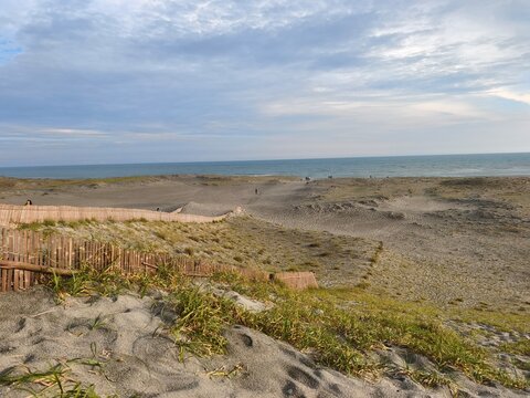 Quiet sandy coast and sea beneath a cloudy sky in Hamamatsu Japan