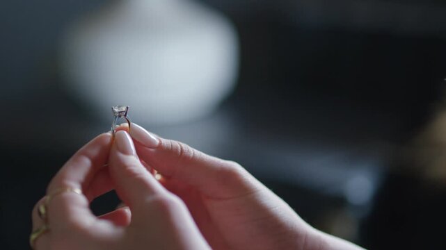 Close Up of Woman Hands Holding Solitaire Diamond Engagement Ring, Female Fingers Examining Sparkling Ring Jewelry Footage, Wedding Proposal and Love Concept Video, Romantic Jewelry Detail Scene