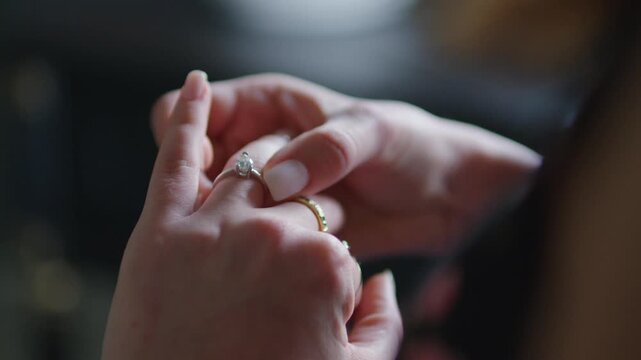 Close Up of Woman Hands Holding Solitaire Diamond Engagement Ring, Female Fingers Examining Sparkling Ring Jewelry Footage, Wedding Proposal and Love Concept Video, Romantic Jewelry Detail Scene