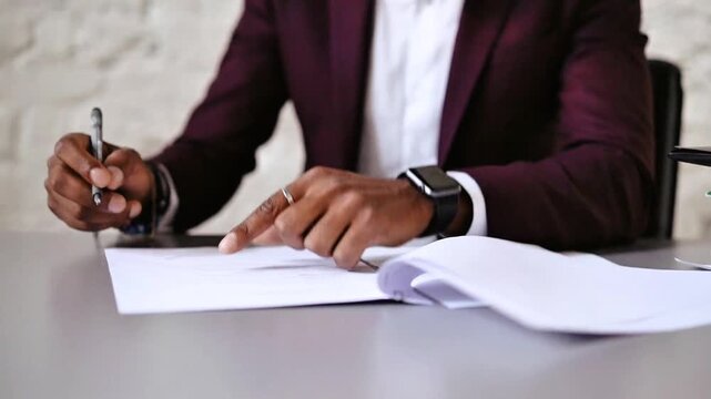 Professional Businessman in Suit Signing Legal Document or Contract Close-up