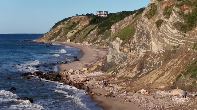 aerial view of two people walking on the mohegan bluffs beach in block island rhode island