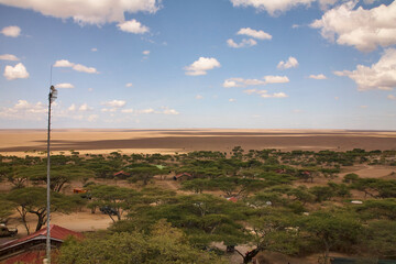 Trockener Kraterboden mit Funkmast und Gebäuden im Ngorongoro-Schutzgebiet © Jane Be. The Picture