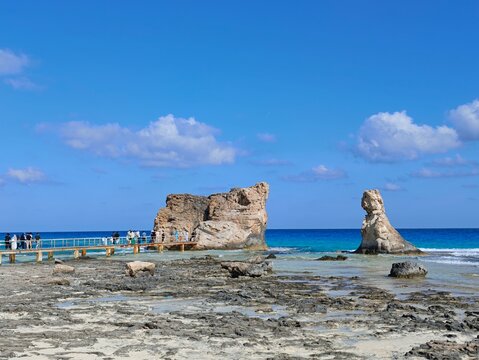 Famous Cleopatra Rock Formation and Wooden Bridge with Tourists at Marsa Matruh Beach Egypt