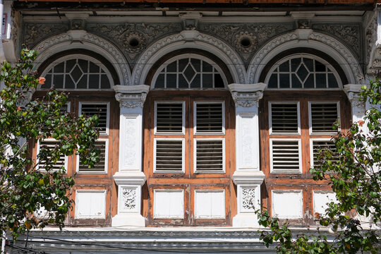 Ornate Arched Windows on Historic Shophouse in George Town Penang