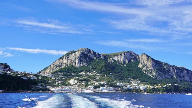 Island of Capri  with wake from ferry in the Gulf of Naples, Italy