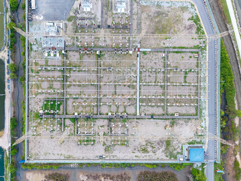 Aerial view of a high-voltage inlet substation in the Tenaga Nasional Berhad grid, featuring electrical transformers and metal structures in Central Seberang Perai, Penang, Malaysia.