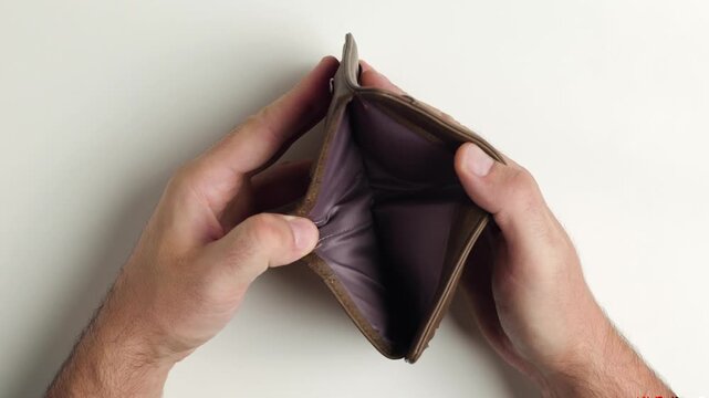 Personal finance and budget management, hands opening a brown leather wallet, overhead view of money and credit card storage, financial planning