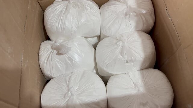 High Angle Shot of White Rice Flour Bags Packed in Cardboard Box