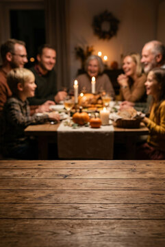Blurred background of a warm family Thanksgiving dinner with empty rustic wooden table