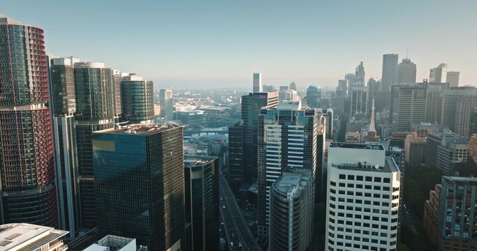 Aerial view of the Sydney skyline with modern glass skyscrapers, busy streets, and urban density in Sydney, New South Wales, Australia.