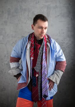 Young man adjusting one of many ties around his neck