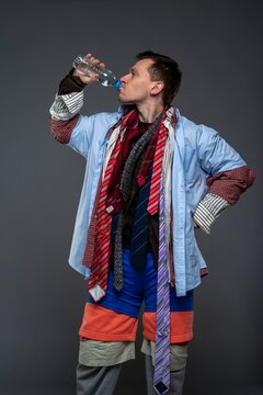 Thirsty overdressed man drinking water from a plastic bottle
