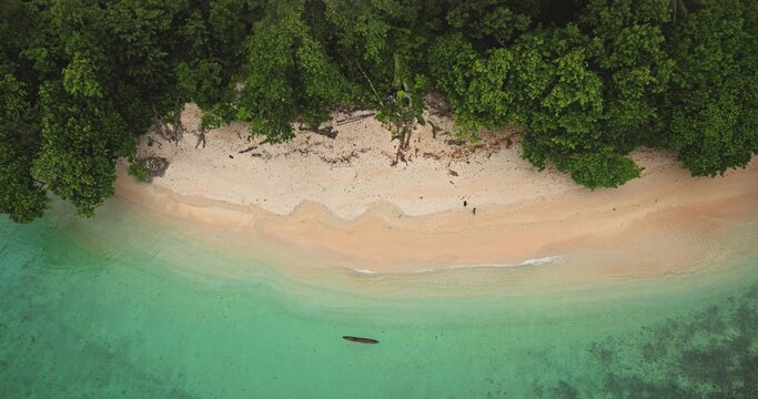 Aerial view of a tropical beach with turquoise water, white sand, and lush green trees in Solomon Islands, Solomon Islands, Solomon Islands.