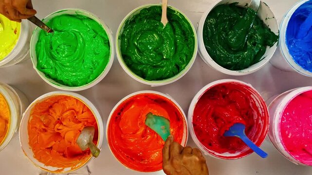 Top view, colorful fabric printing inks in white buckets.
Stirring the ink for multicolored tee shirt printing .
colorful of ink forprint tee shirt in tee shirt factory.
colorful ink background.