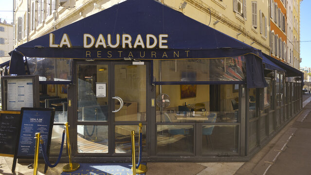 MARSEILLE, FRANCE - SEPTEMBER 16, 2026 - La Daurade restaurant facade and outdoor seating area on a sunny day in Marseille