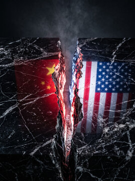 china and usa split on marble slab symbolizes geopolitical conflict diplomatic contradiction and international relation of two countries on dark background with crack