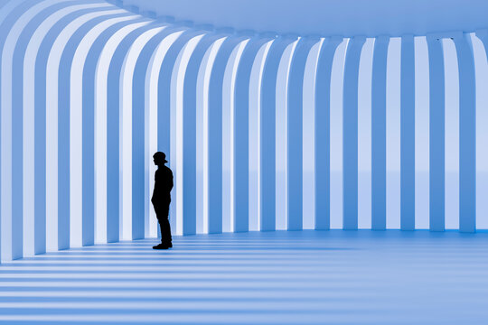 3D silhouette inside luminous blue ribbed corridor with repeating curved columns