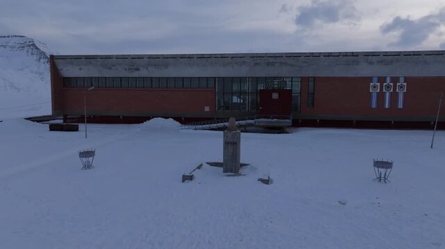 Aerial view of the historic Soviet-era cultural center in the abandoned mining town of Pyramiden surrounded by snow-covered ground in Pyramiden, Svalbard, Svalbard and Jan Mayen.