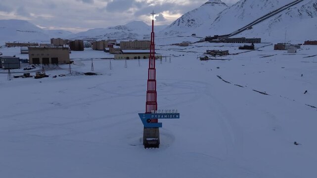 Aerial view of the Pyramiden monument in a snow-covered landscape with abandoned Soviet-era buildings under an arctic sky in Pyramiden, Svalbard, Svalbard and Jan Mayen.