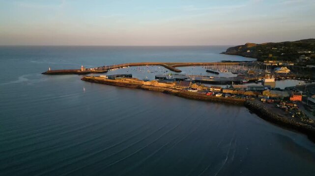 Drone perspective of the historic harbor piers and coastline in Howth, Ireland