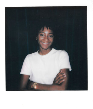 Analog image of happy Black woman with crossed arms