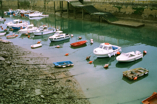 Small boats resting at low tide in a harbour